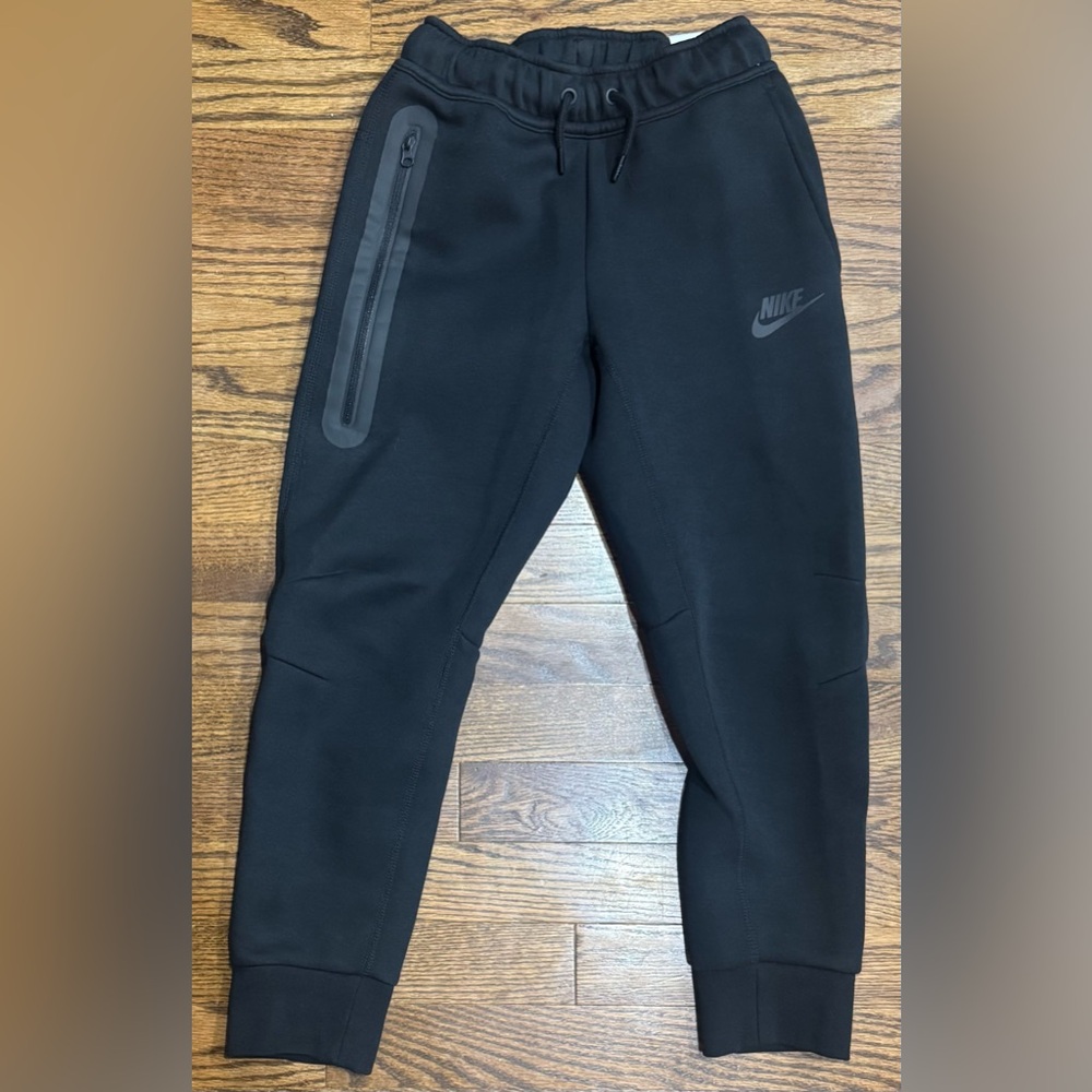 New without tags, Nike Tech black pants, youth size small.